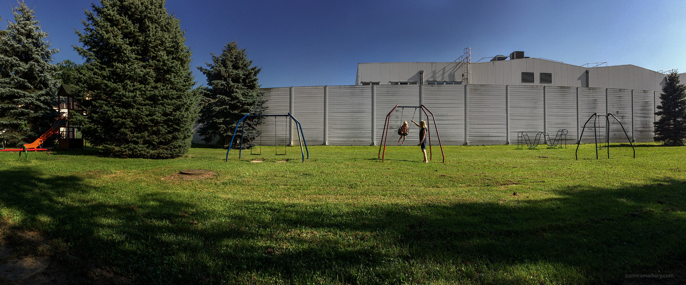 Kids swing in industrial area | PANORAMA DIARY